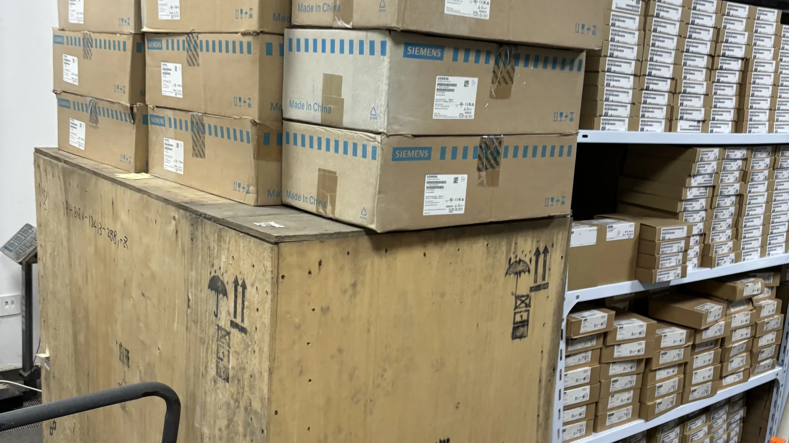 Wooden crates, cardboard cartons and shelving in a warehouse.