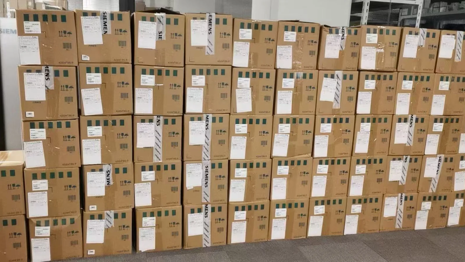 Cardboard cartons and product boxes stacked in a warehouse.